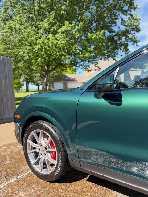 Deep green Porsche Cayenne detailed in a Central Texas driveway