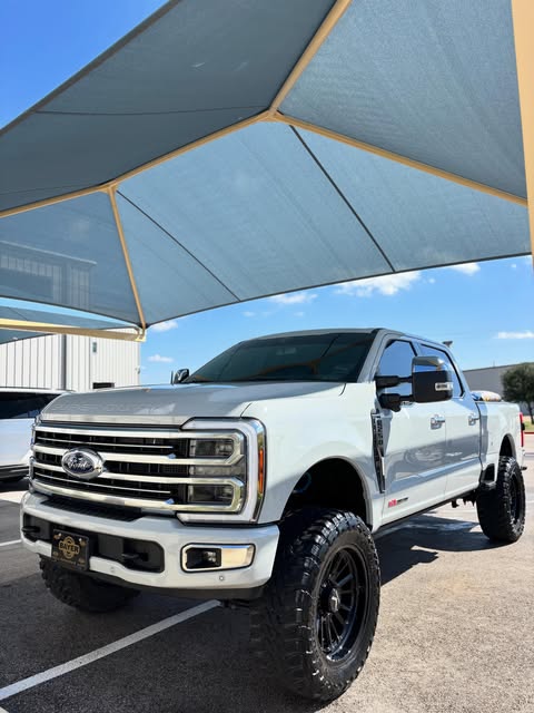 Lifted white Ford F-250 Platinum after a full detail